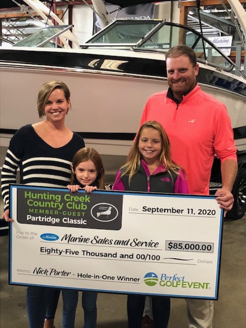Nick Porter with family and hole-in-one award