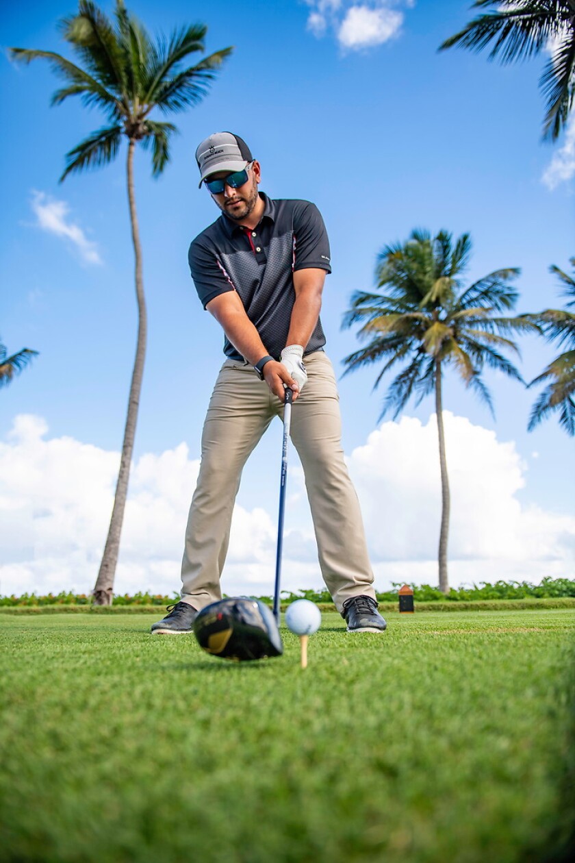 Golfer in Puerto Rico with tropical setting in background