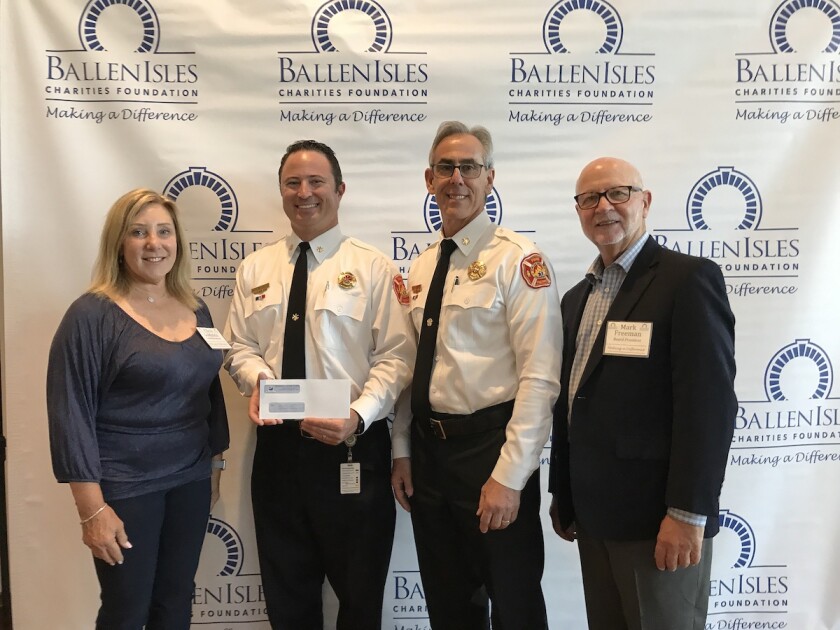 Chere Goldstein (from left), of BallenIsles Charities Foundation; Corey Bessette, EMS chief of Palm Beach Gardens Fire Rescue; Keith Bryer, fire chief of Palm Beach Gardens Fire Rescue; and Mark Freeman, president of BallenIsles Charities Foundation