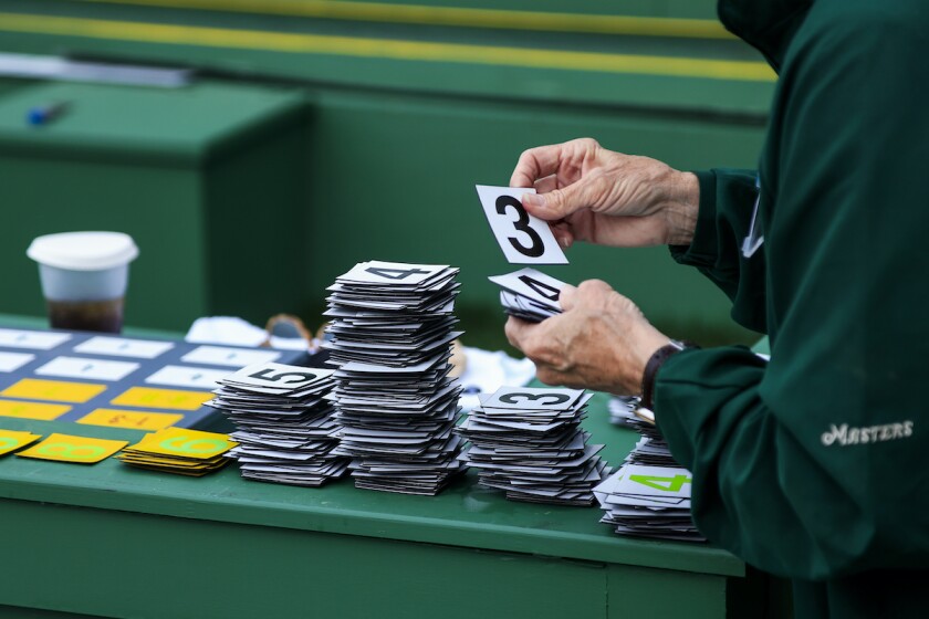 Volunteer sorts numbers for scoreboard at 2021 Masters