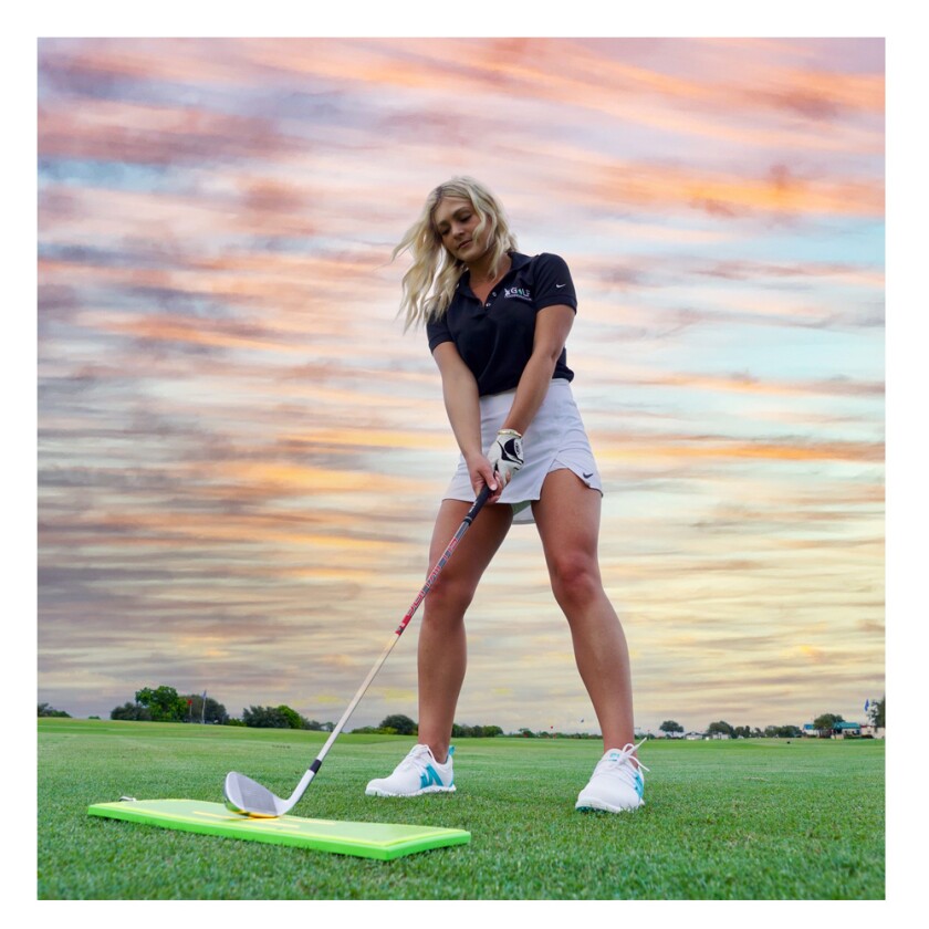 Divot-Board-Emily-hitting-off-board-Amazon.jpg