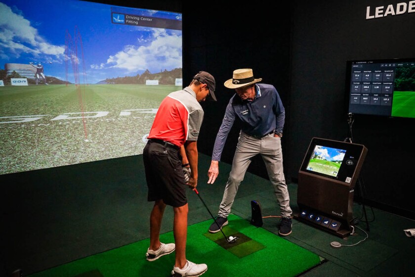 David Leadbetter provides instruction in new GOLFZON simulator room.jpg